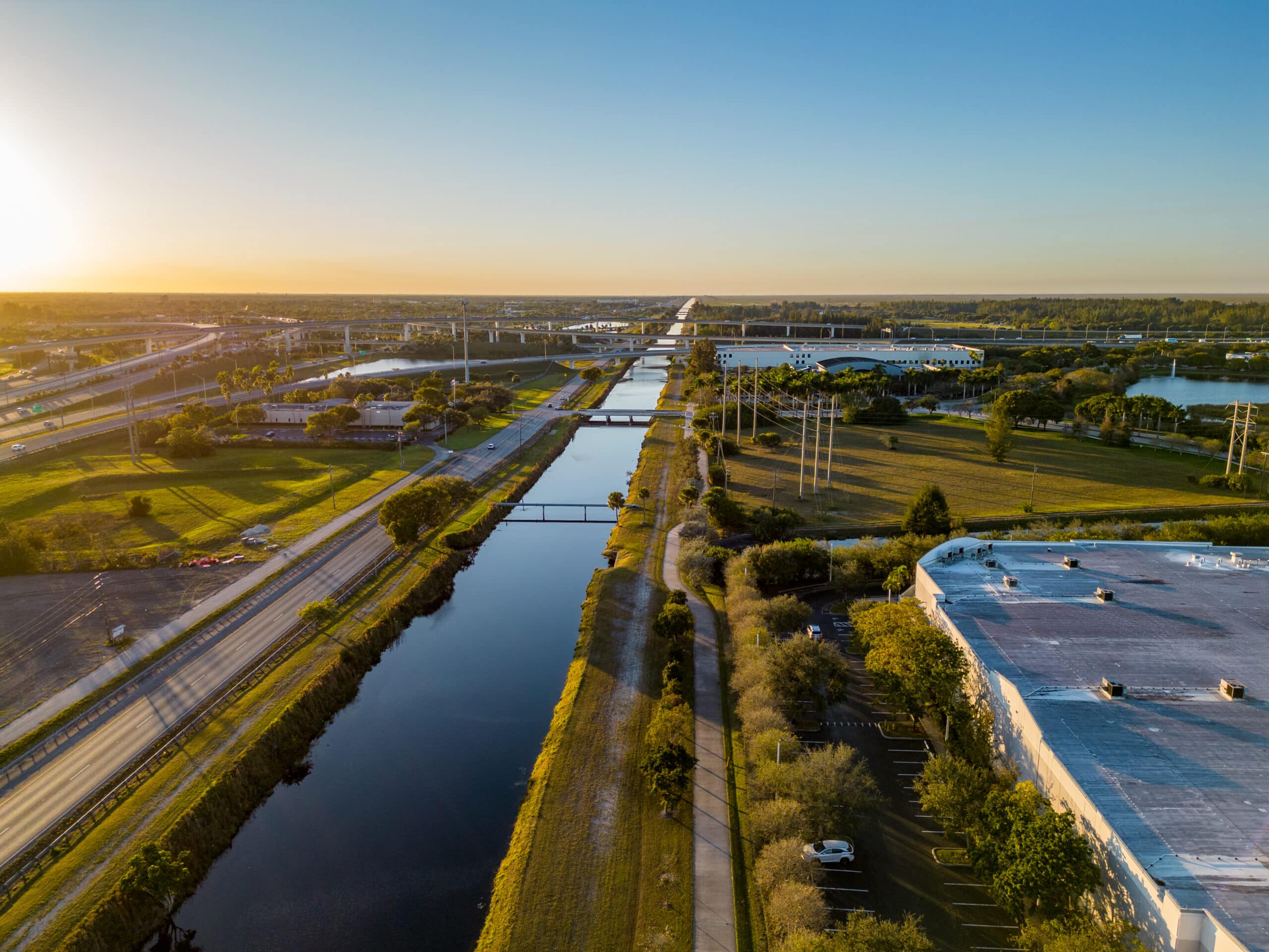 An aerial view of a highway at sunset.