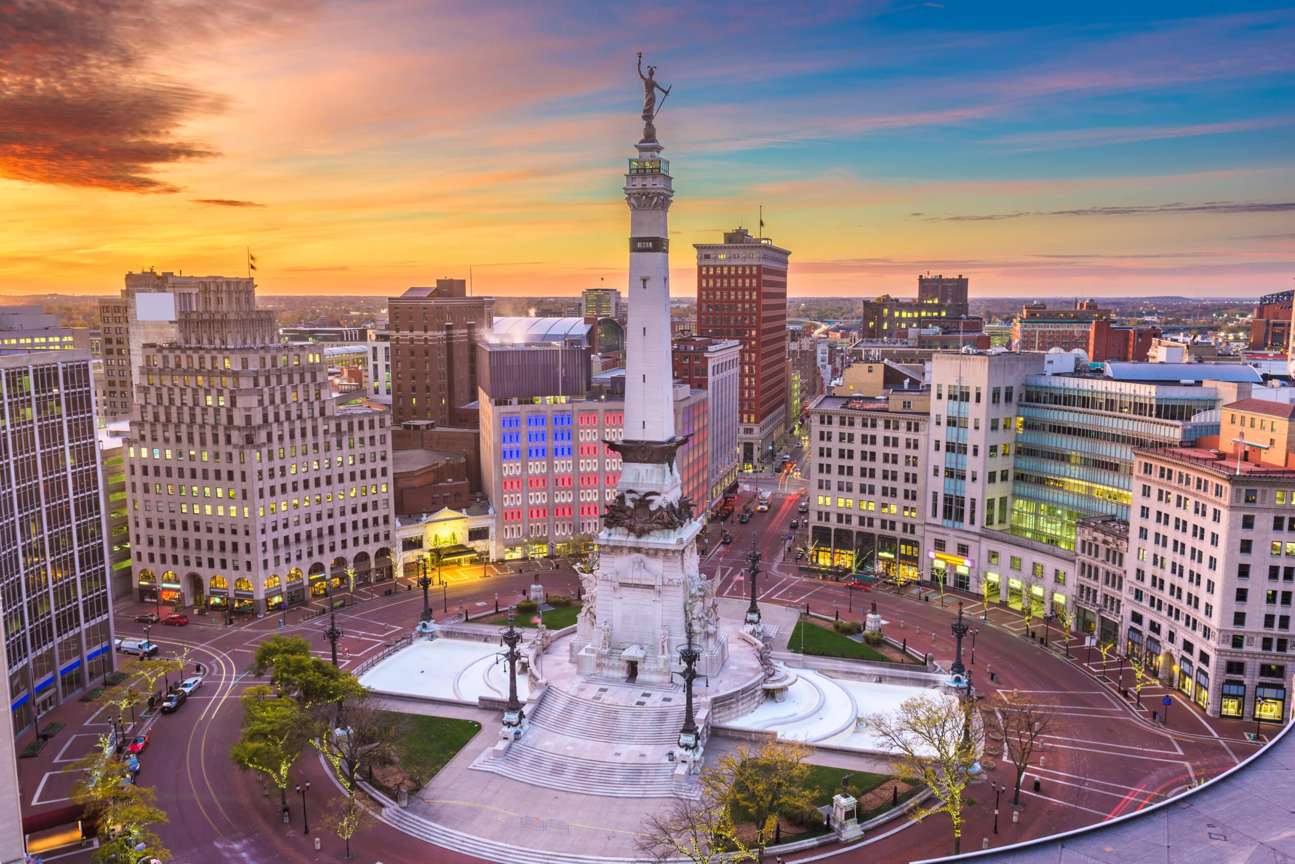 An aerial view of the city of indianapolis at sunset.