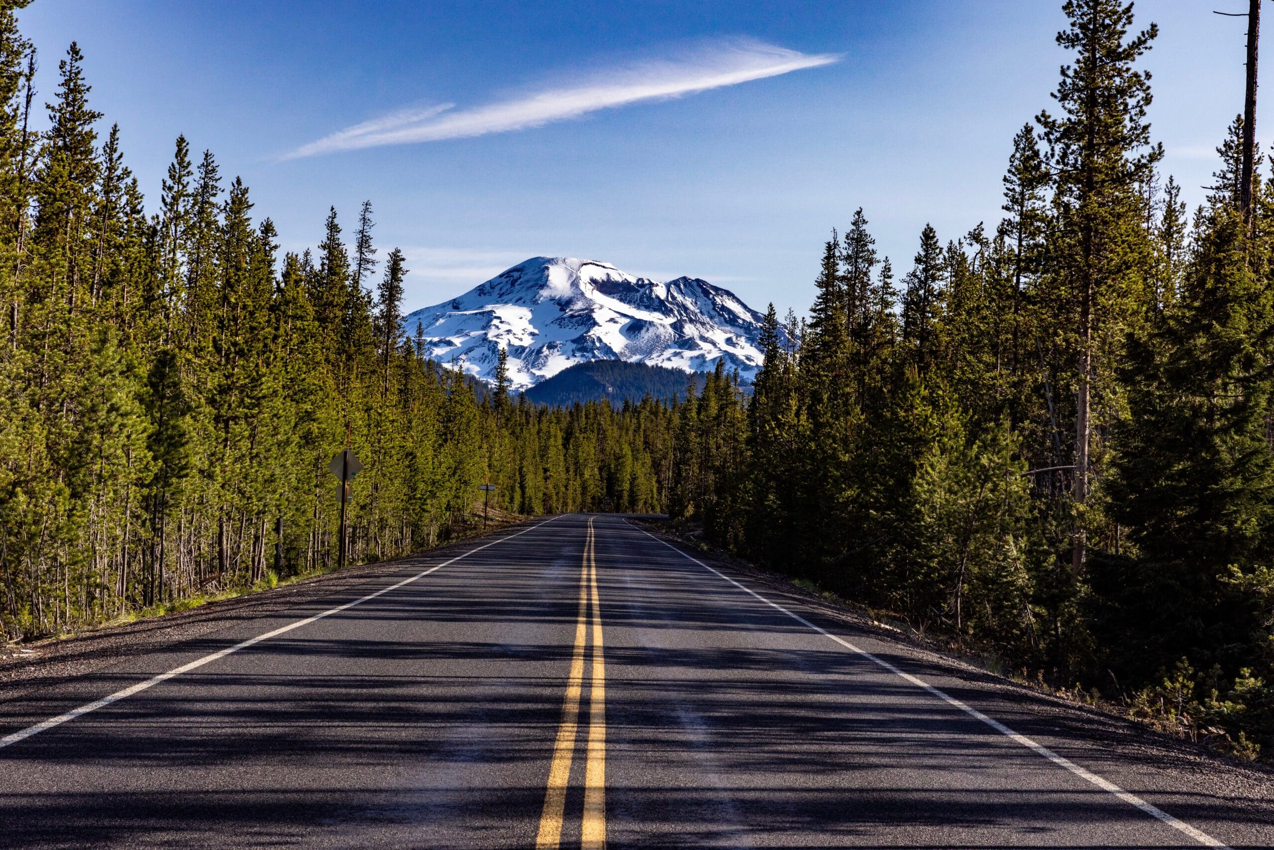 A road with a mountain in the background.