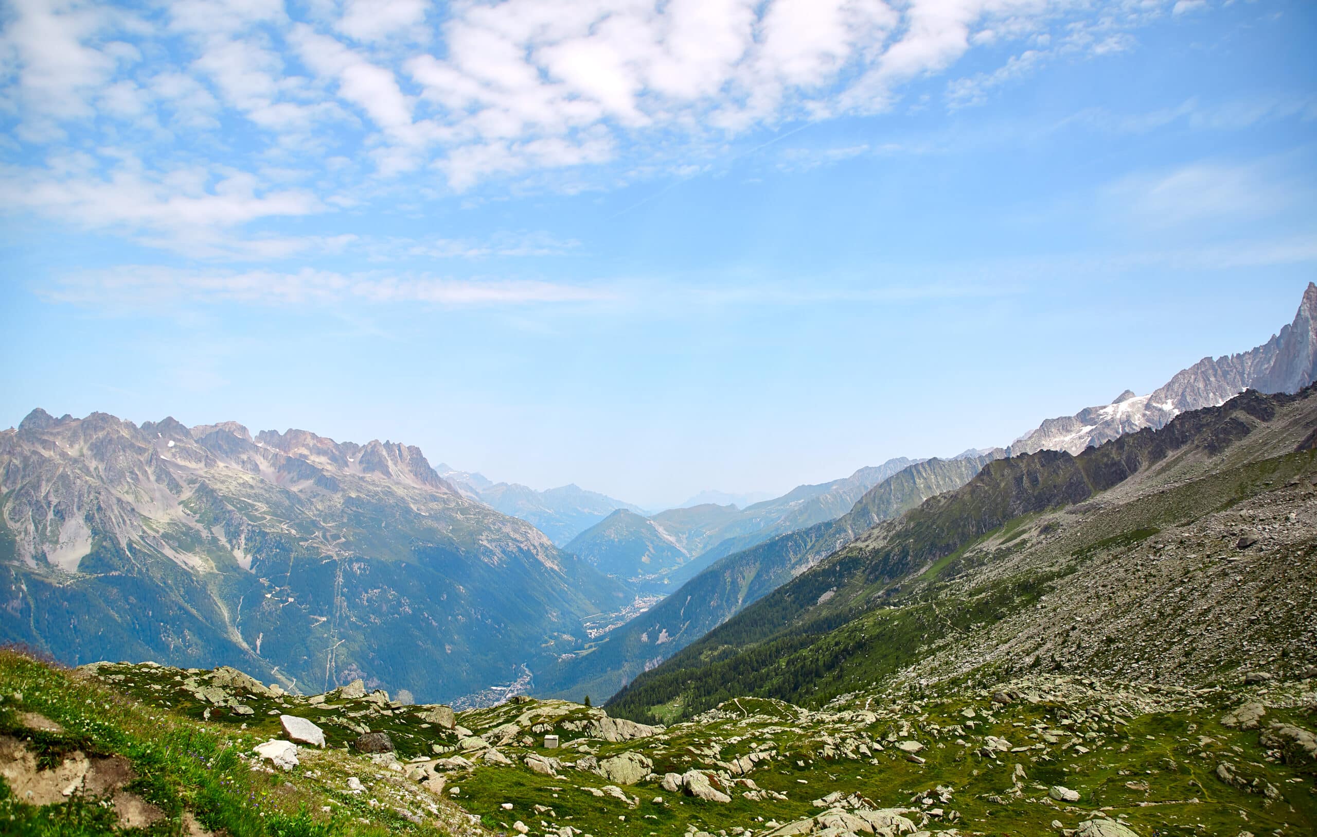 A view of a valley with mountains in the background.