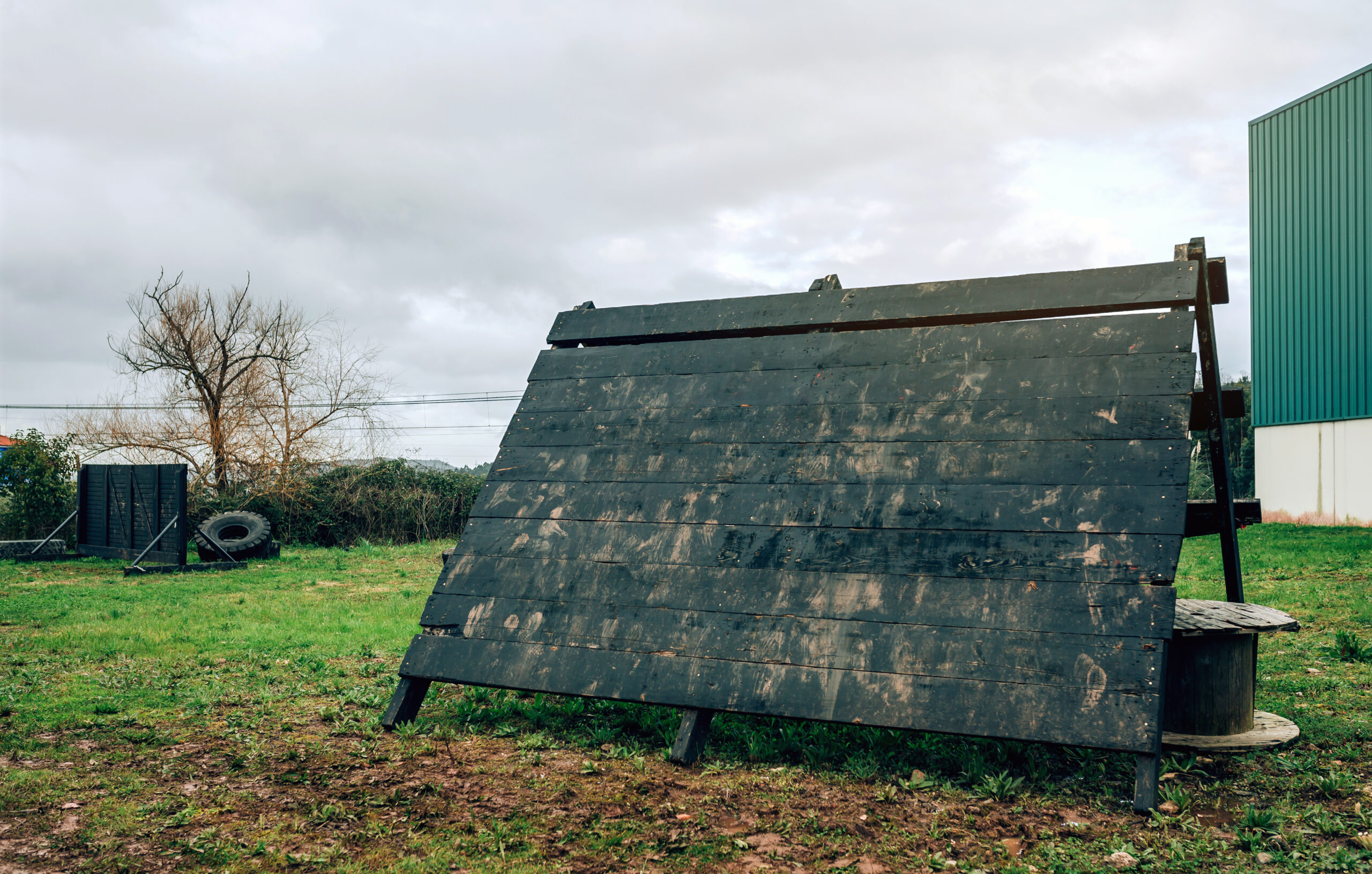 A solar panel in a field next to a building in Vermont.