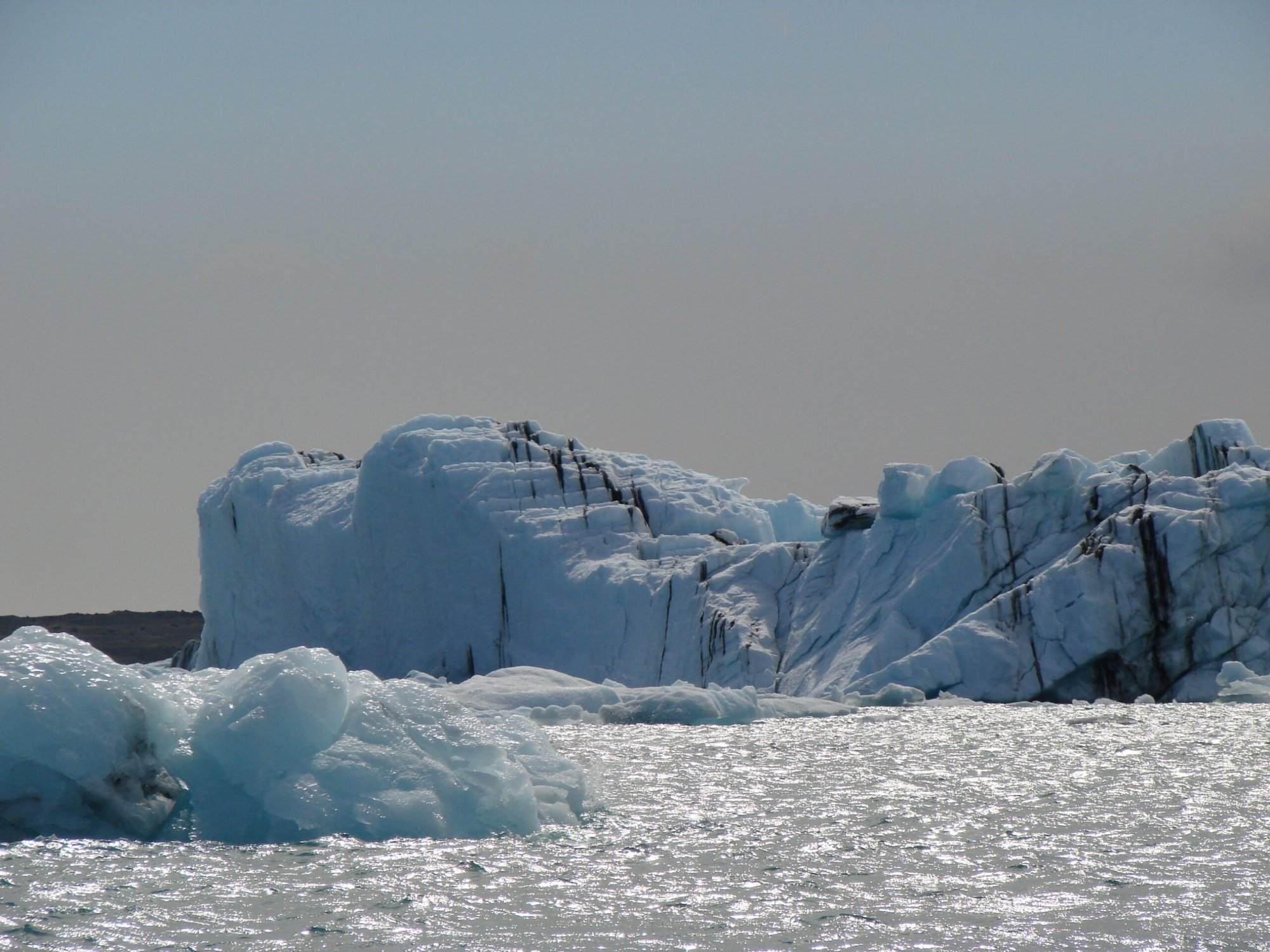 A group of icebergs floating in the water.