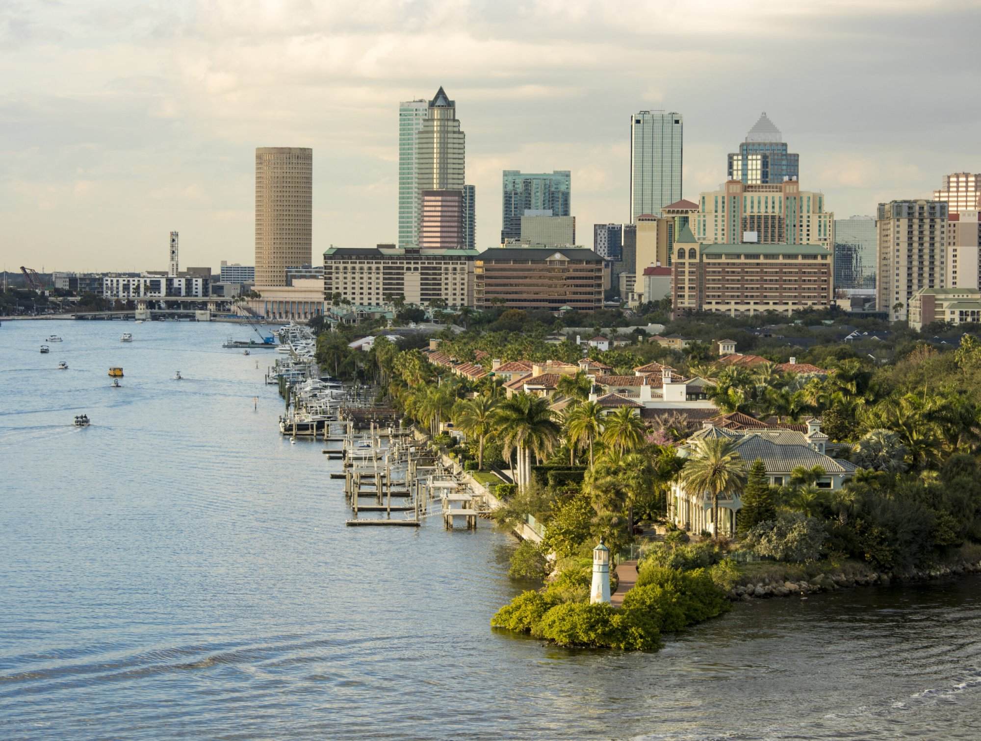 The skyline of tampa, florida is seen from the water.