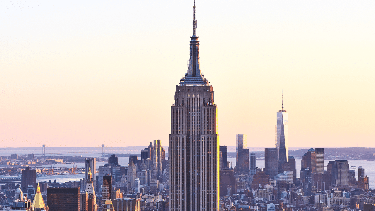 A view of the Empire State Building against the backdrop of other skyscrapers in New York City during sunset, reminiscent of the excitement leading up to a major event like the Run-Up.